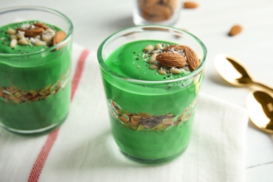 Photo of Glass cups of spirulina smoothie on table