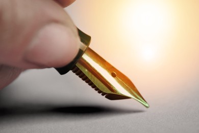 Woman writing with fountain pen, closeup view