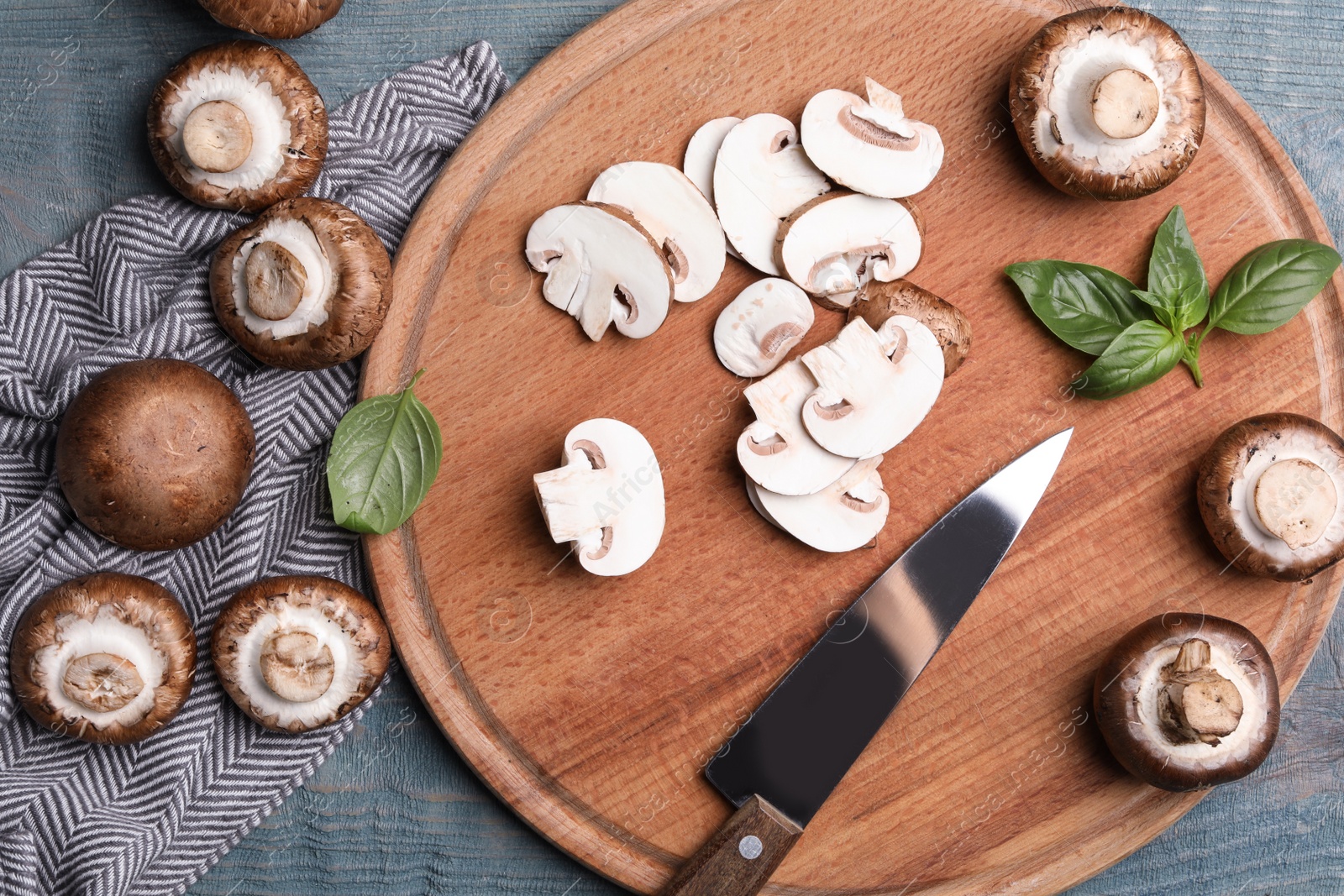 Photo of Flat lay composition with fresh raw mushrooms on wooden table