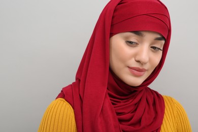 Photo of Portrait of Muslim woman in hijab on light gray background