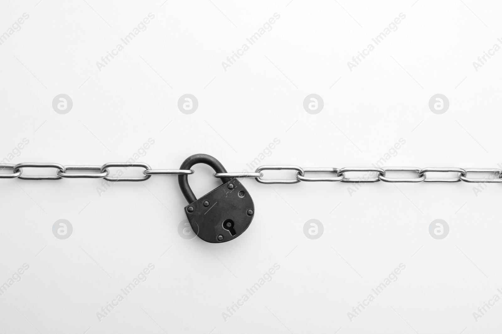 Photo of Steel padlock and chain isolated on white, top view. Safety concept