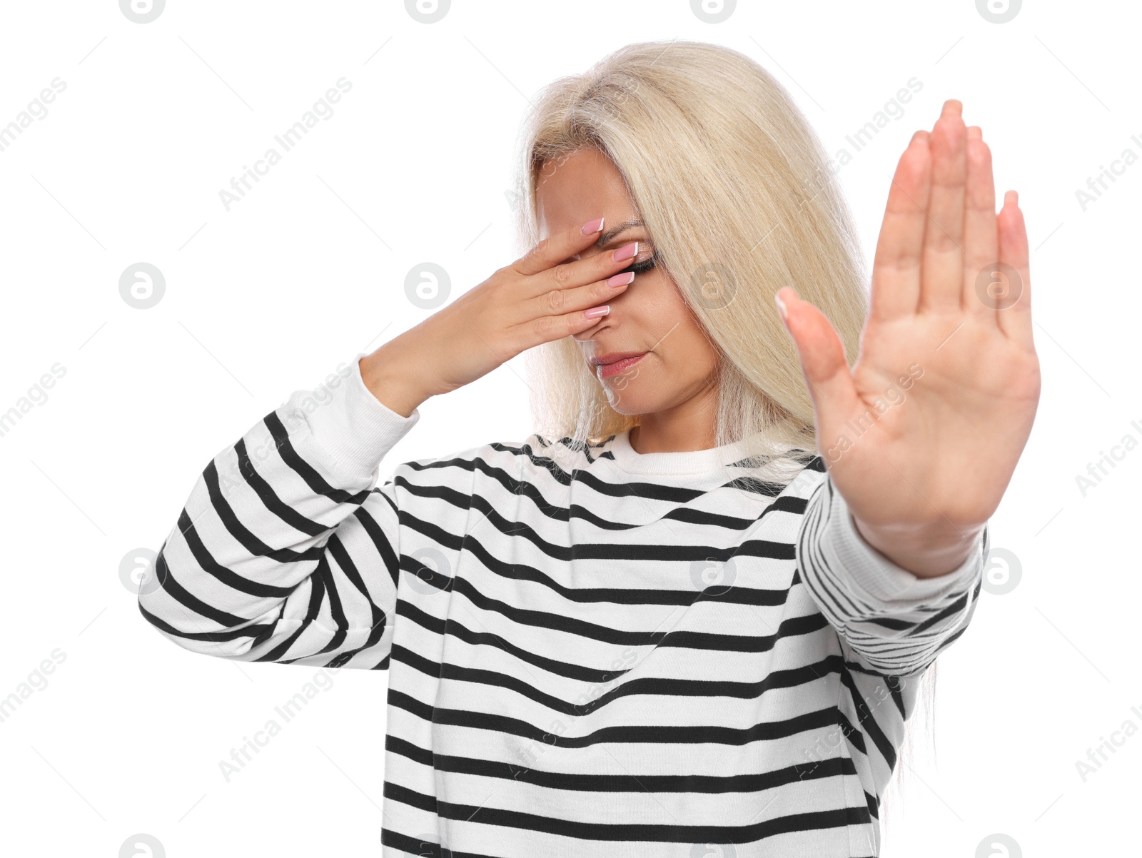 Photo of Embarrassed woman covering face with hand on white background