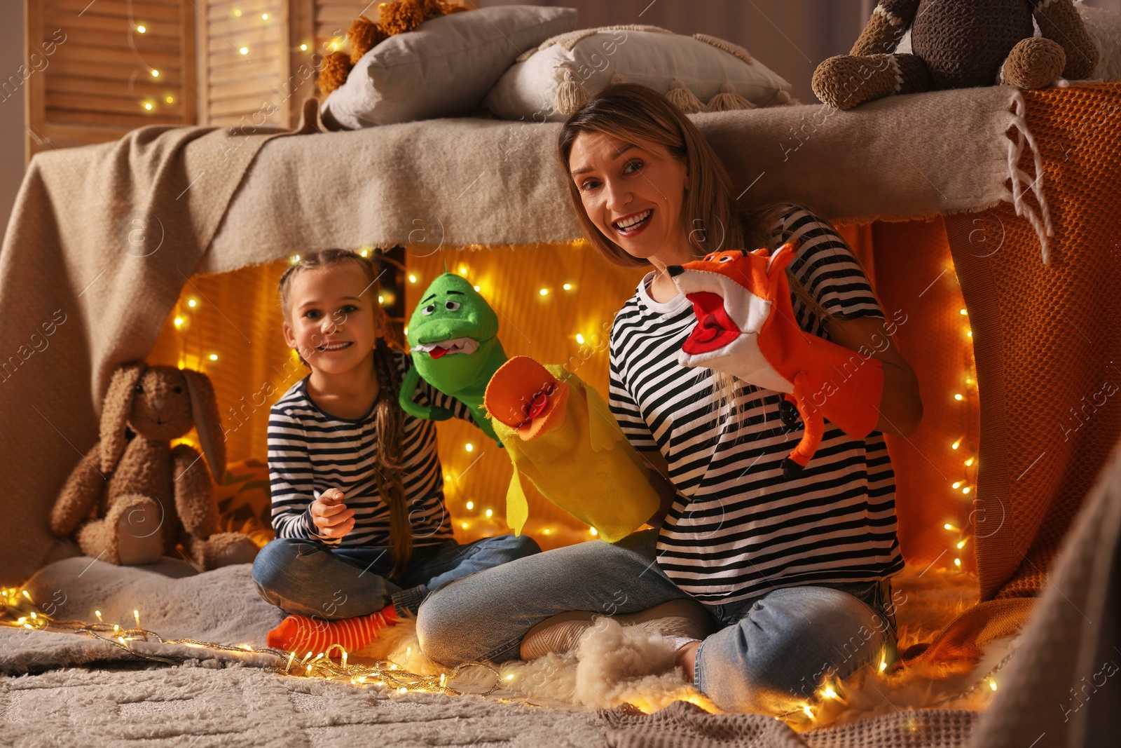 Photo of Mother and her daughter playing with toys in play tent at home