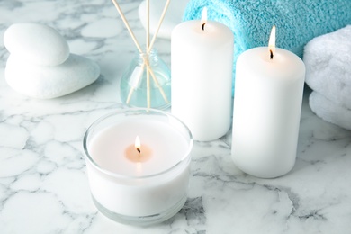 Photo of Beautiful spa composition with candles and stones on marble background