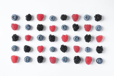 Photo of Composition with raspberries, blackberries and blueberries on white background