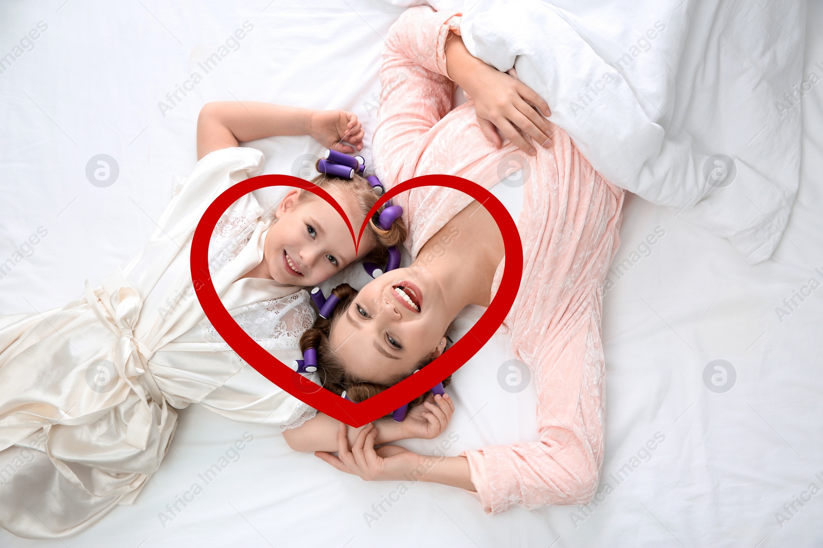 Image of Illustration of red heart and happy mother with daughter with curlers lying on bed, top view