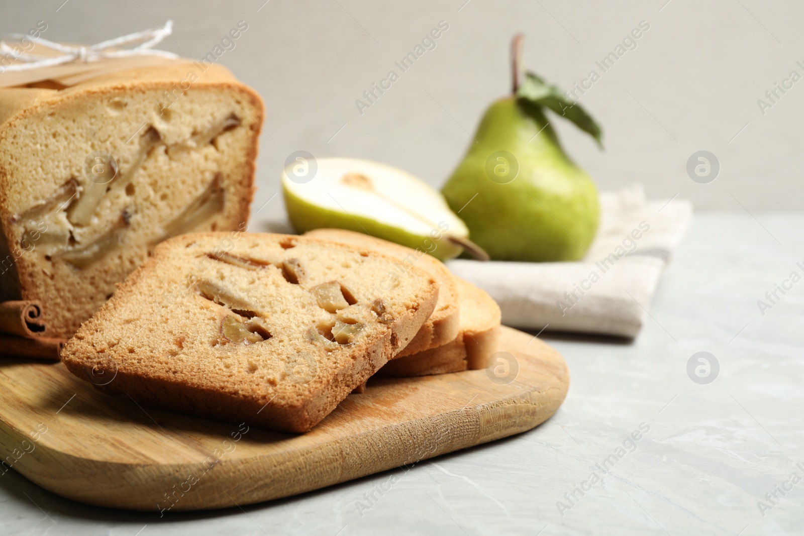 Photo of Tasty pear bread on light grey marble table, closeup. Homemade cake