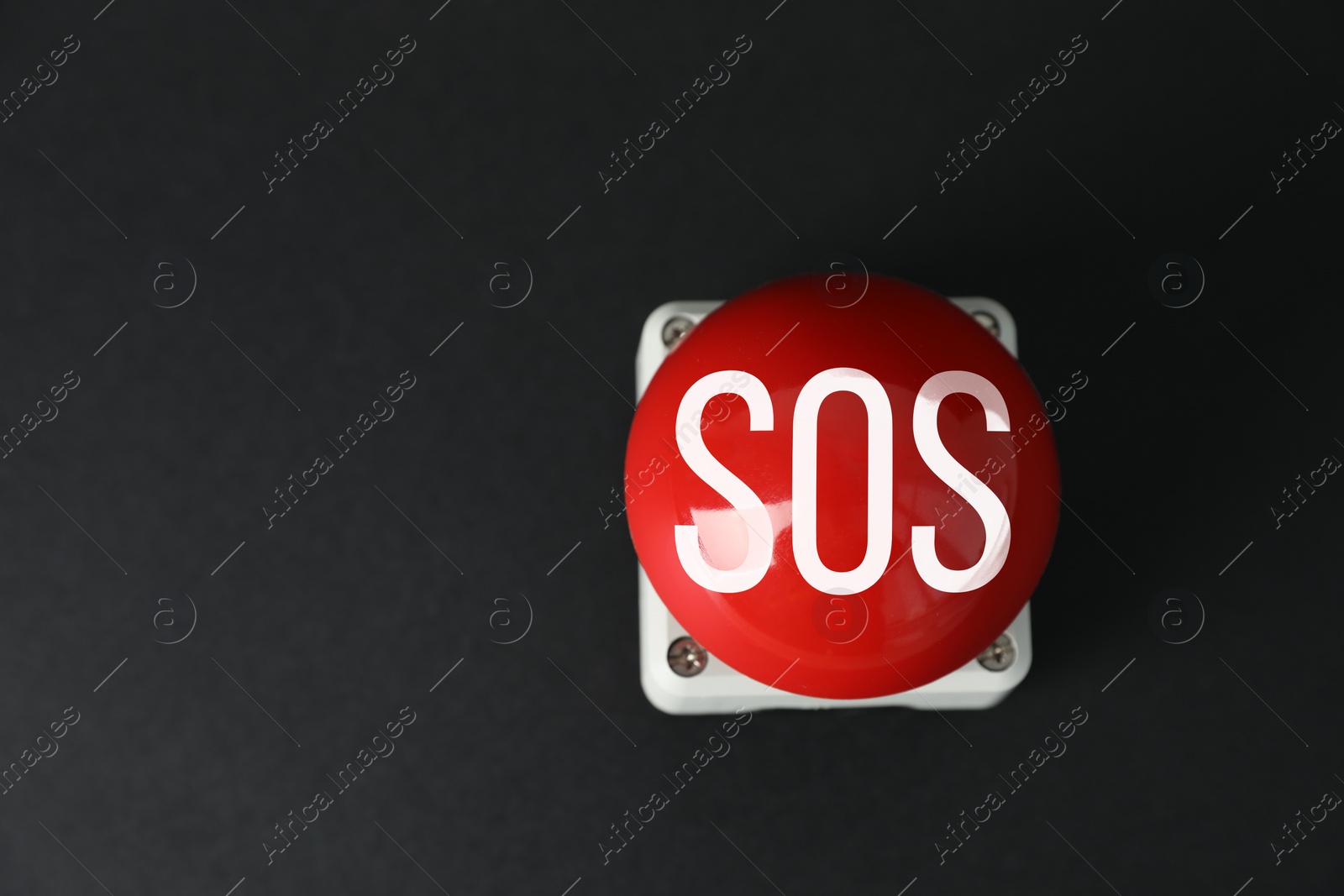 Image of Red SOS button on black background. Space for text