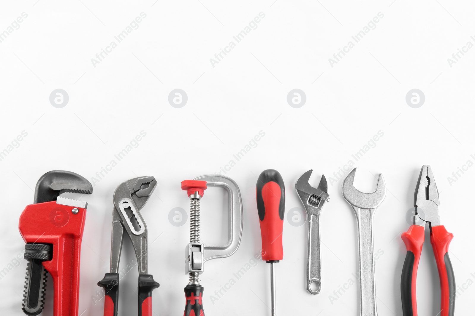 Photo of Flat lay composition with construction tools on white background. Space for text