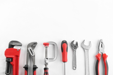 Photo of Flat lay composition with construction tools on white background. Space for text