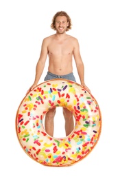 Photo of Attractive young man in swimwear with doughnut inflatable ring on white background
