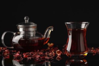 Photo of Glass of traditional Turkish tea on black table, space for text