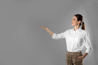 Photo of Portrait of young female teacher on grey background. Space for text