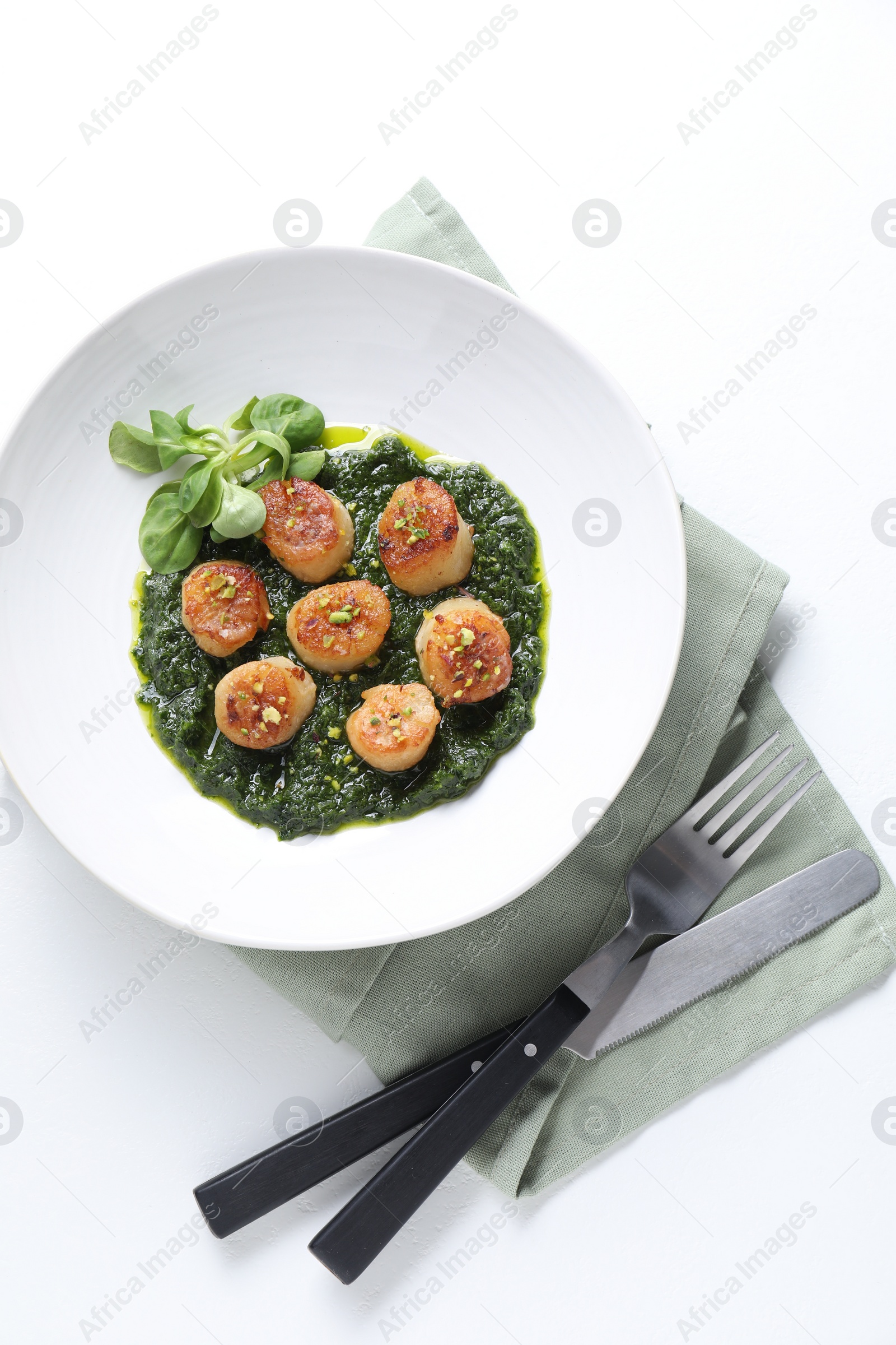 Photo of Delicious fried scallops in bowl served on white table, flat lay
