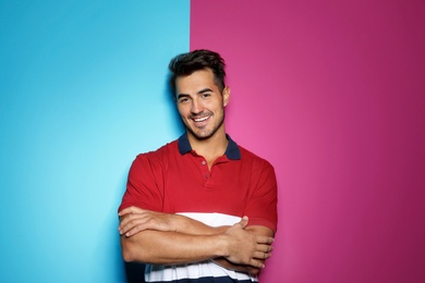 Photo of Young man with trendy hairstyle posing on color background