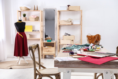 Photo of Fashion designer's workplace in studio. Creating new clothes