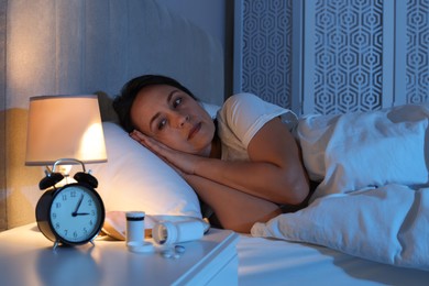 Mature woman suffering from insomnia in bed at night