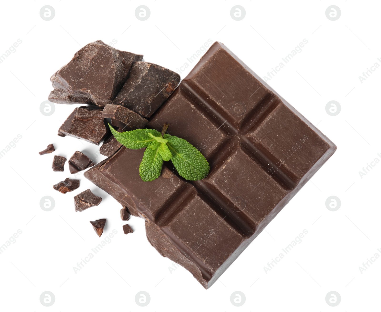 Photo of Tasty chocolate pieces and mint on white background, top view