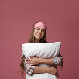 Photo of Beautiful woman with pillow on dusty rose background. Bedtime