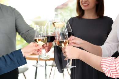 People with glasses of wine on blurred background, closeup