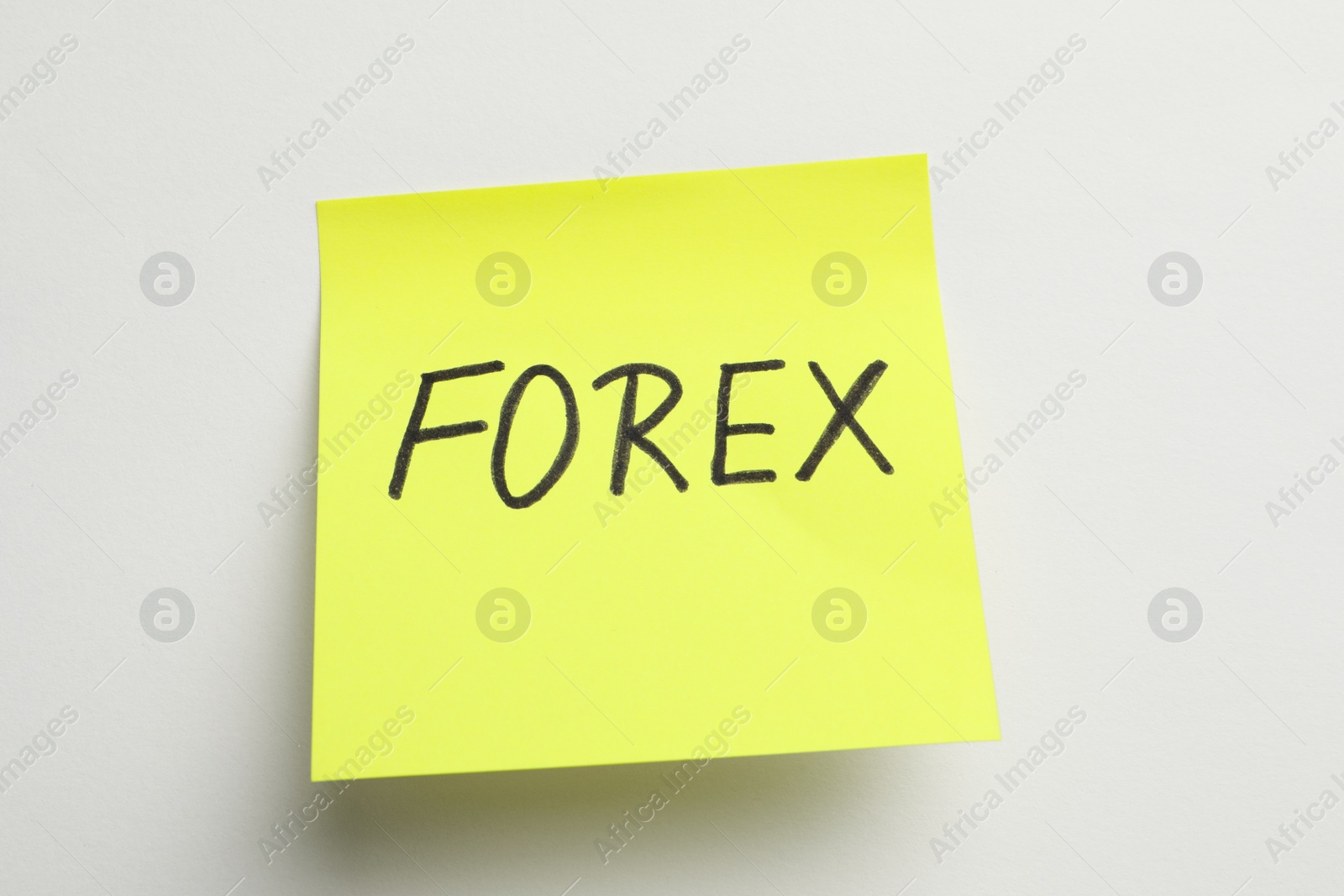 Photo of Sticky note with word Forex on white background, closeup