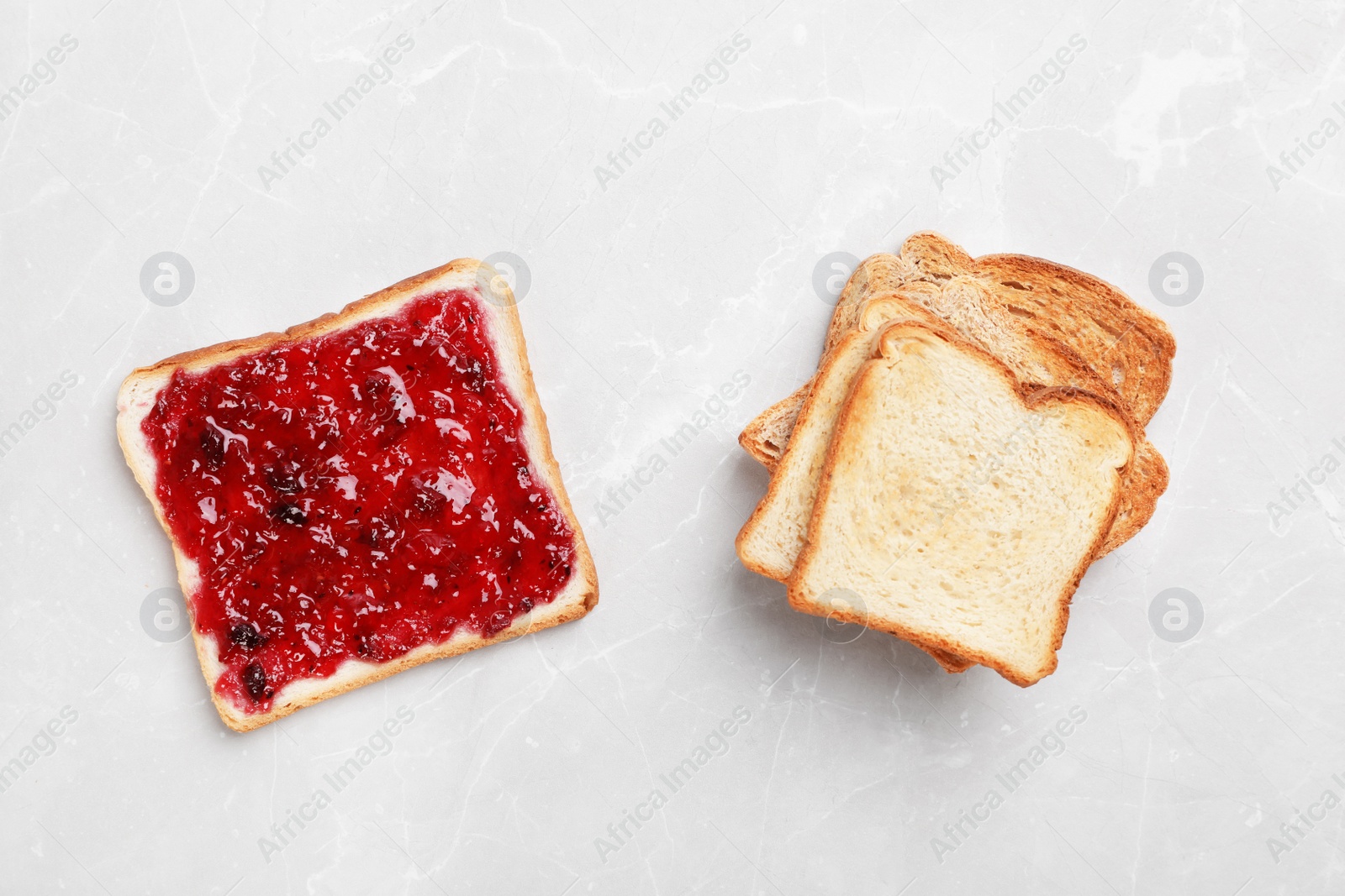 Photo of Toasts with jam on light background, top view