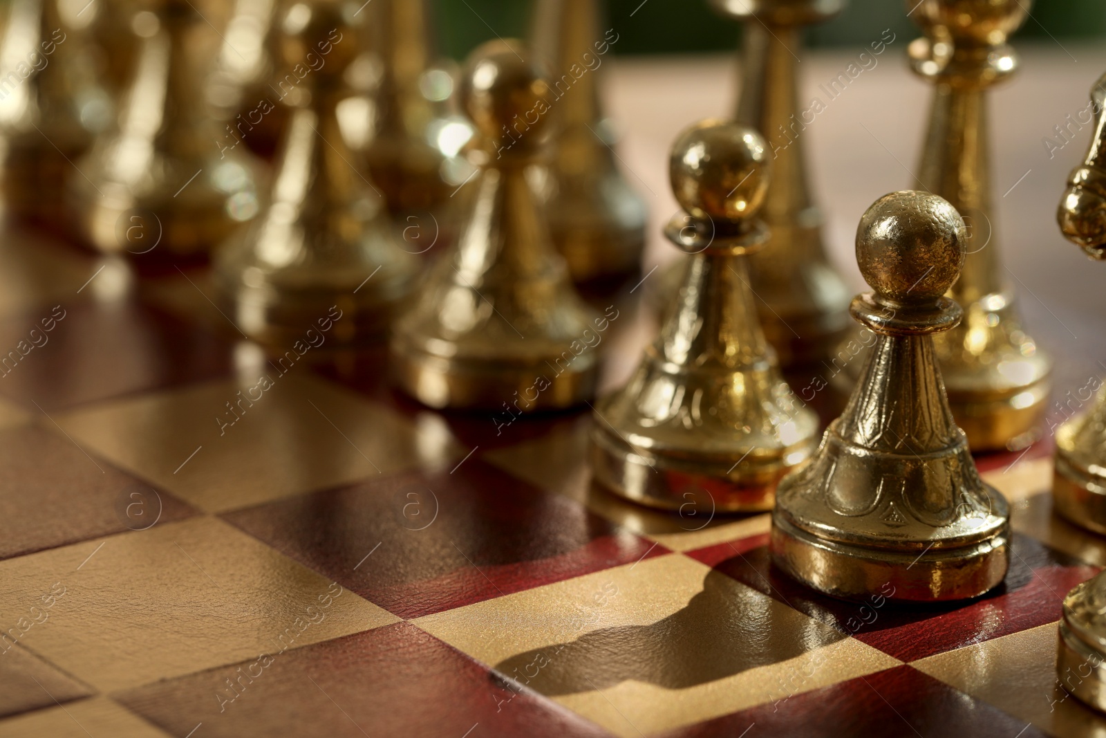 Photo of Golden pawns on chess board, closeup. Space for text