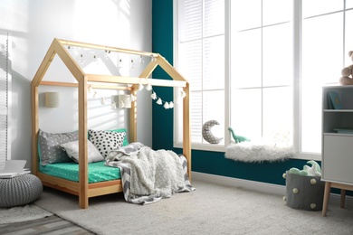 Photo of Cozy child room interior with comfortable bed