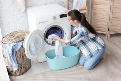 Young woman doing laundry at home