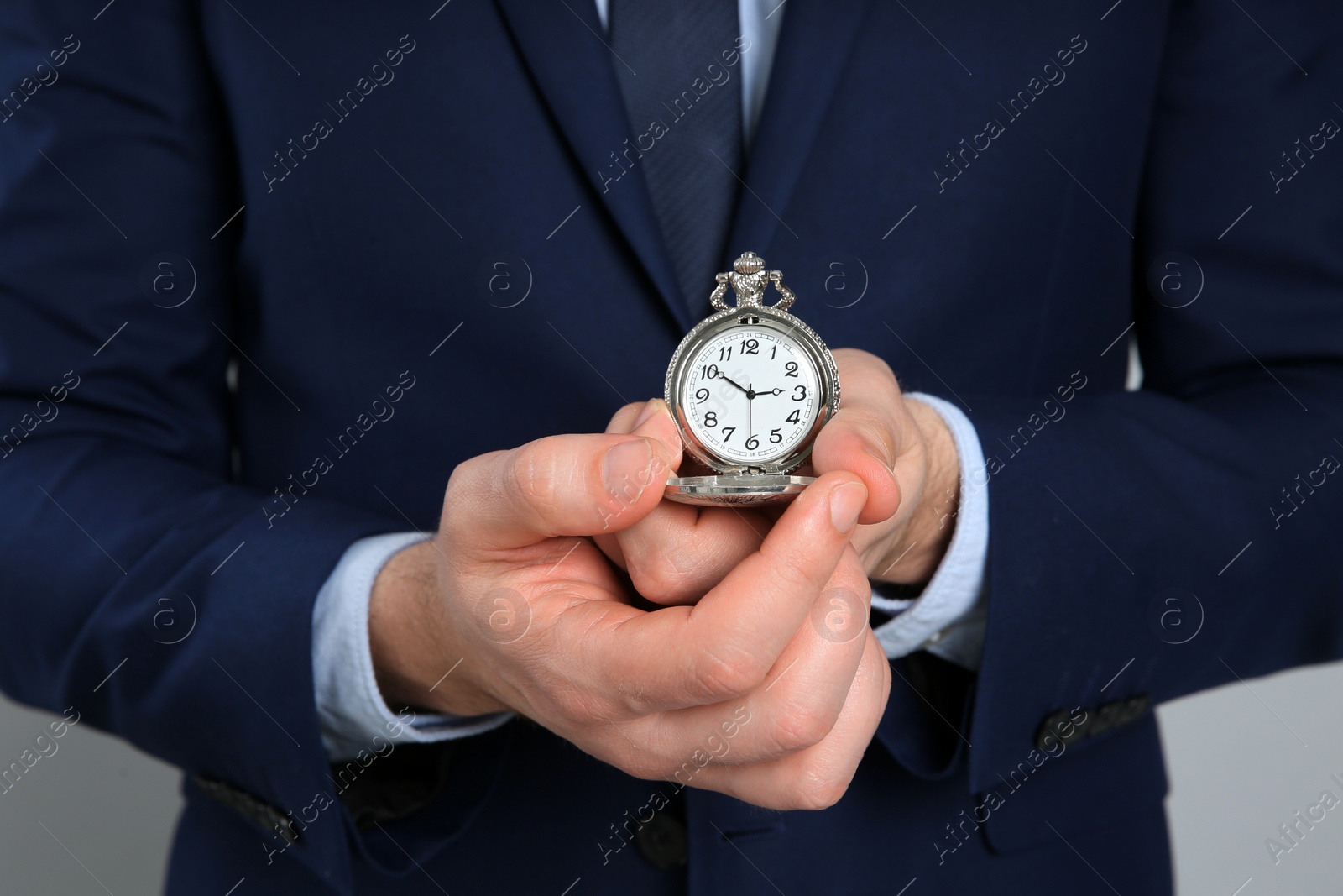 Photo of Businessman holding pocket watch, closeup. Time management