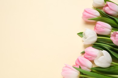 Photo of Beautiful pink spring tulips on beige background, flat lay. Space for text