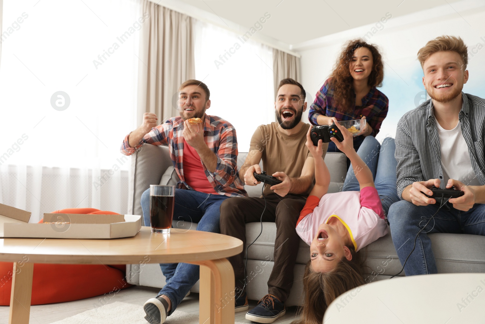 Photo of Emotional friends playing video games at home