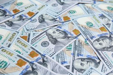 Photo of Many dollar banknotes as background, closeup view