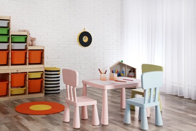 Photo of Modern child room interior with table and chairs