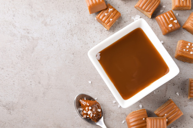 Photo of Salted caramel on light grey table, flat lay. Space for text