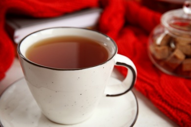 Photo of Cup of hot tea on table, closeup. Winter drink