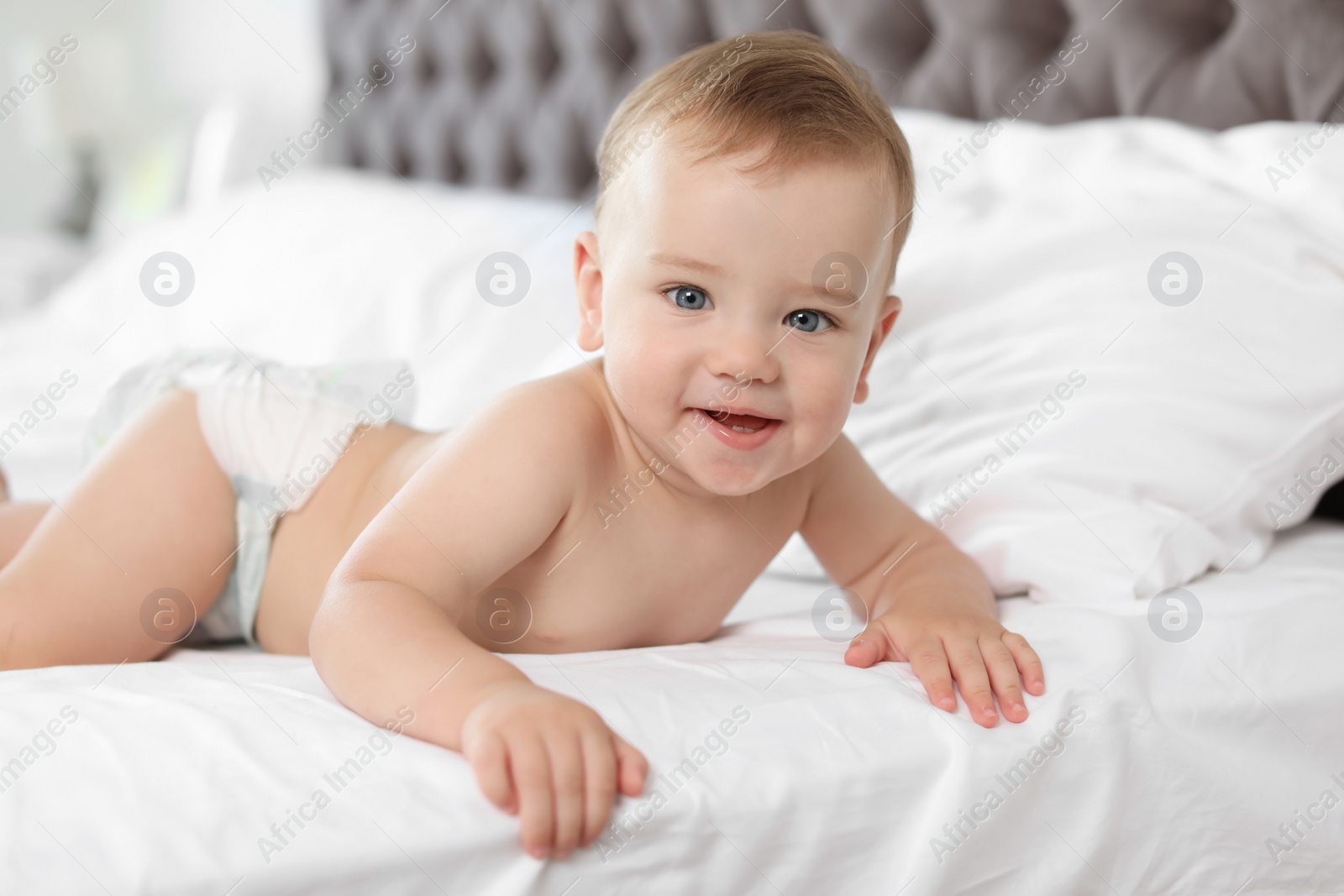 Photo of Adorable little baby on bed at home