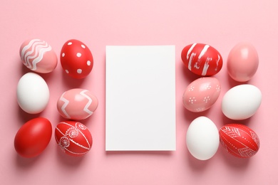 Photo of Flat lay composition of painted Easter eggs and card on color background, space for text