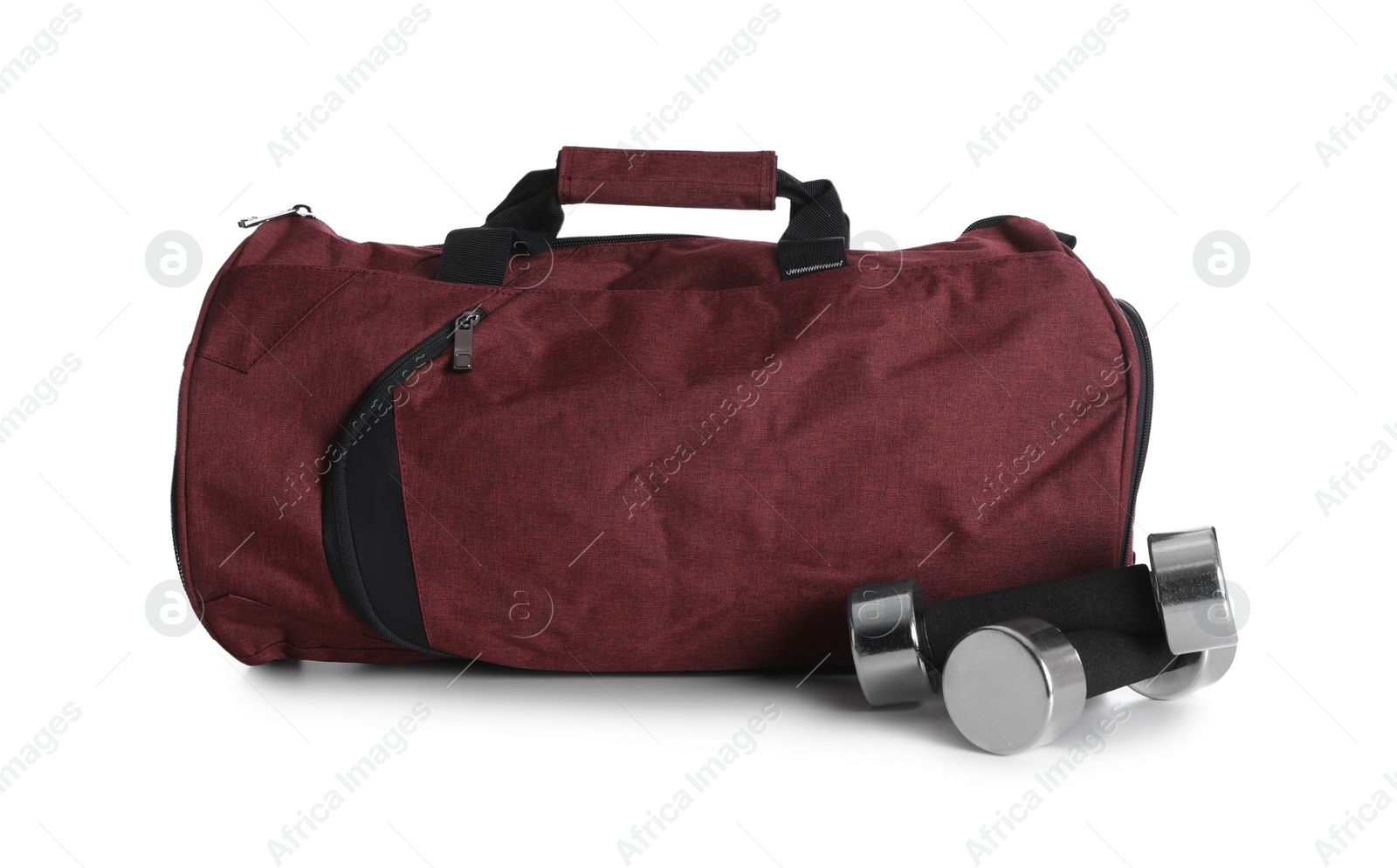 Photo of Sports bag and dumbbells on white background