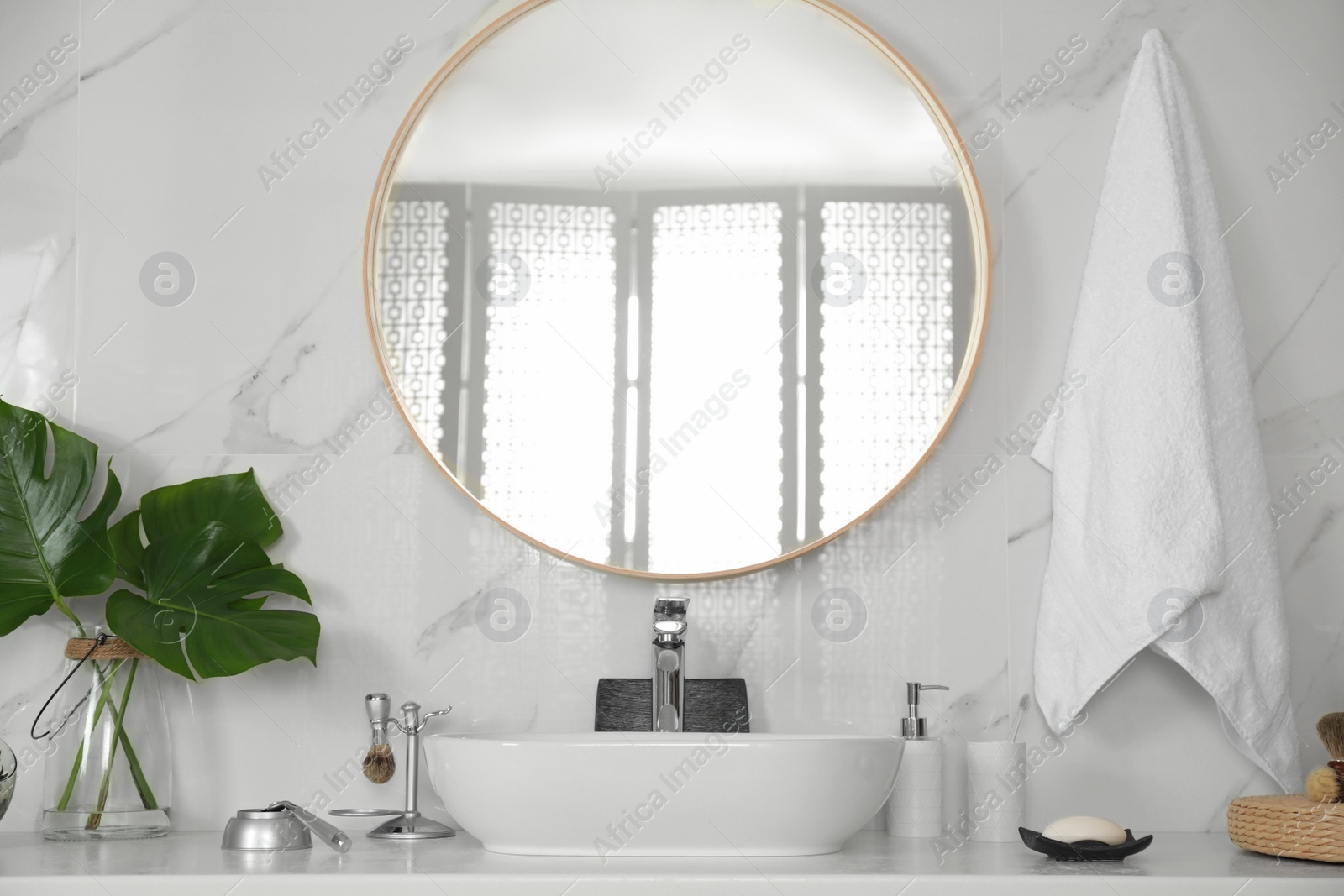 Photo of Stylish bathroom interior with vessel sink and round mirror