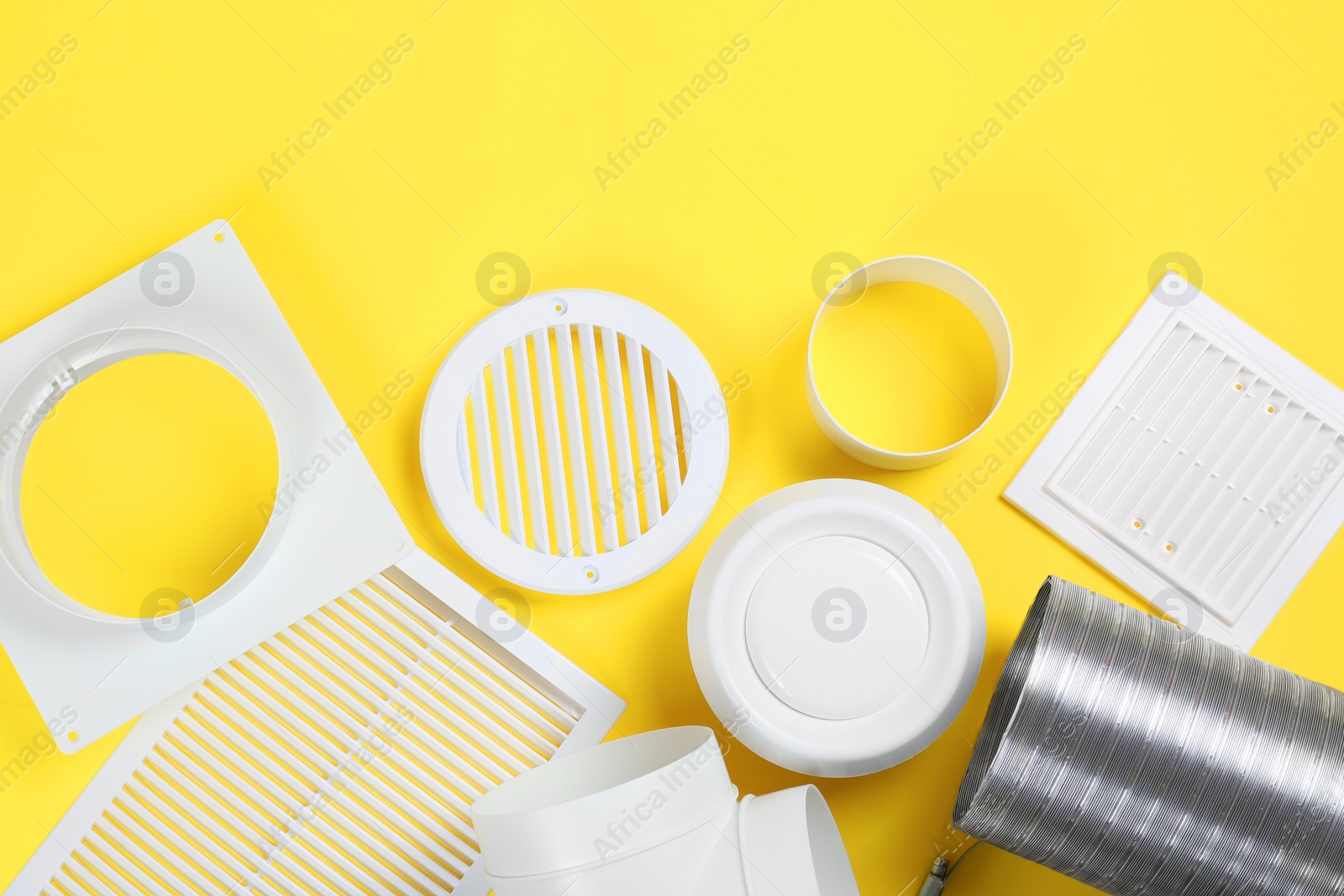 Photo of Parts of home ventilation system on yellow background, flat lay. Space for text