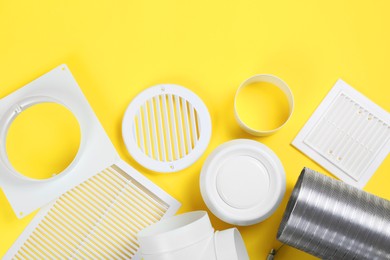 Photo of Parts of home ventilation system on yellow background, flat lay. Space for text