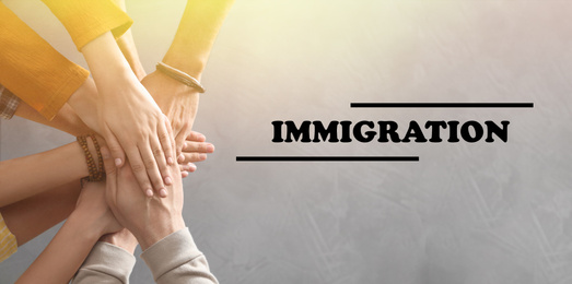 Image of Immigration concept. People holding hands together, top view