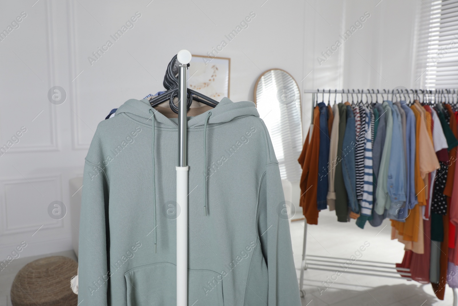 Photo of Racks with stylish clothes indoors. Fast fashion