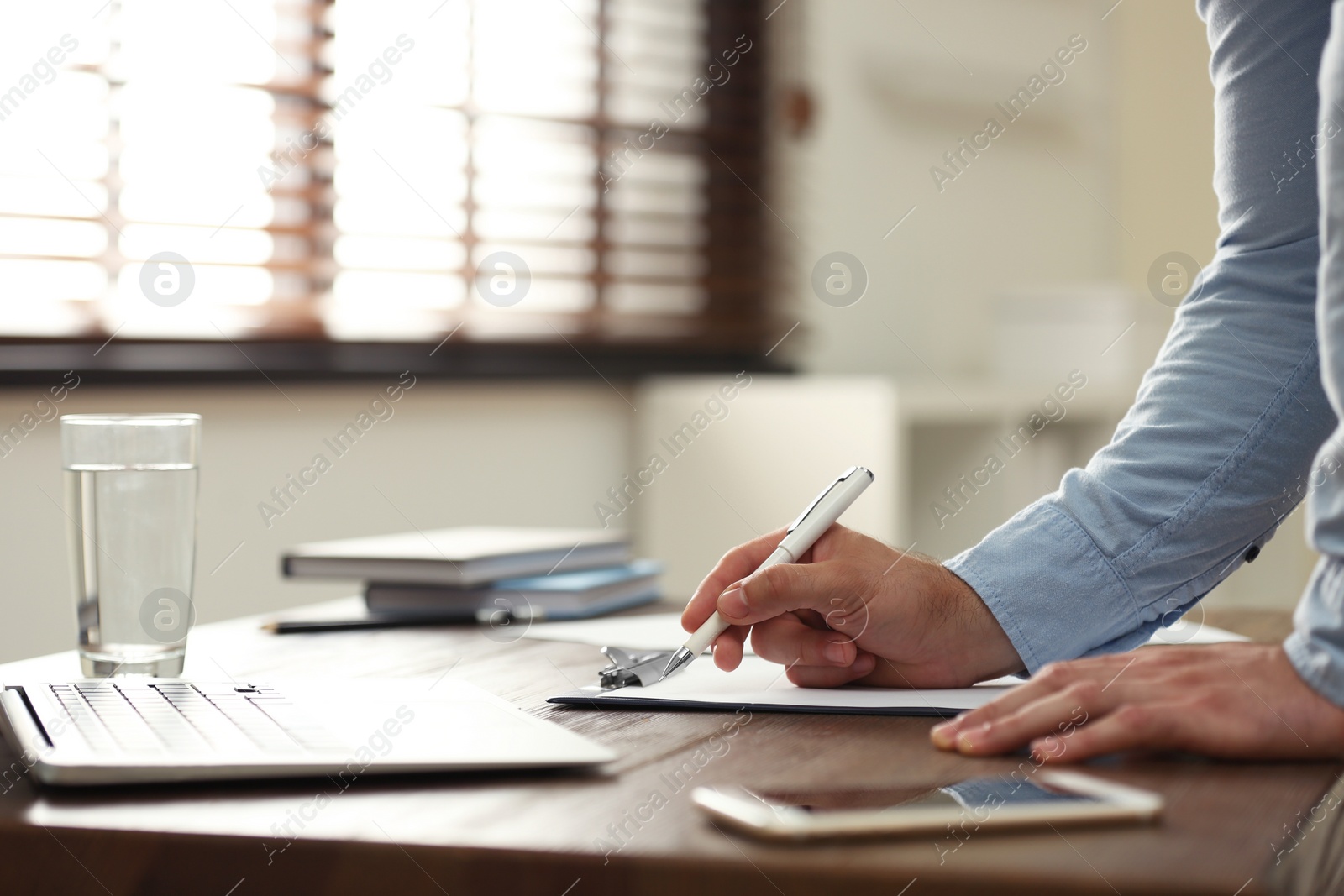 Photo of Business trainer working at table in office, closeup