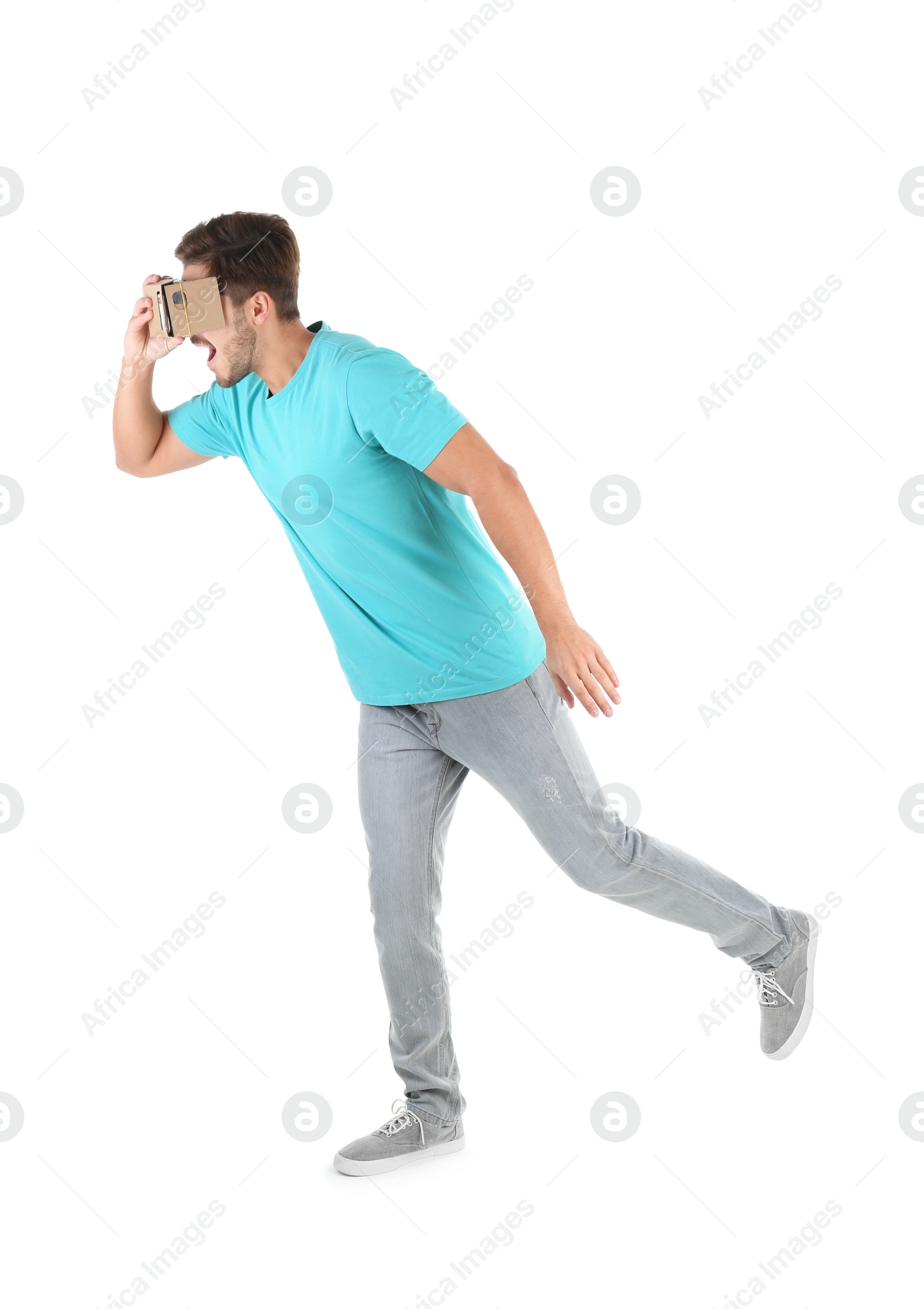 Photo of Young man using cardboard virtual reality headset, isolated on white