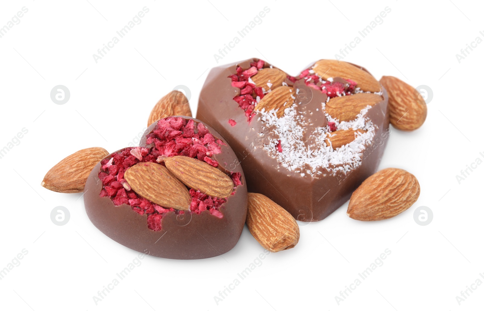 Photo of Tasty chocolate heart shaped candies with nuts on white background