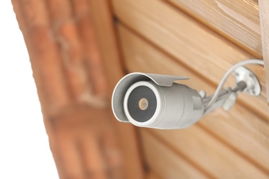 Photo of Modern CCTV security camera on building outdoors. Space for text
