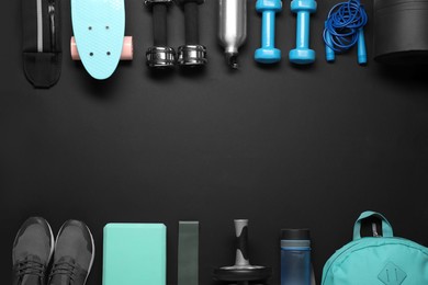 Photo of Frame made of different sports equipment on black background, flat lay. Space for text