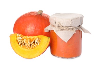 Jar of pumpkin jam and fresh pumpkins on white background